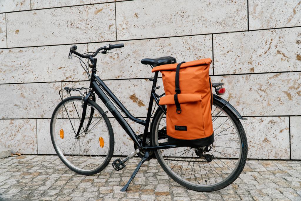BOB Rucksack von Spleen Berlin als Gepäckträgertasche am Fahrrad befestigt, mit Rolltop-Verschluss, veganem Material und hoher Sichtbarkeit für mehr Sicherheit. ©Spleen Berlin